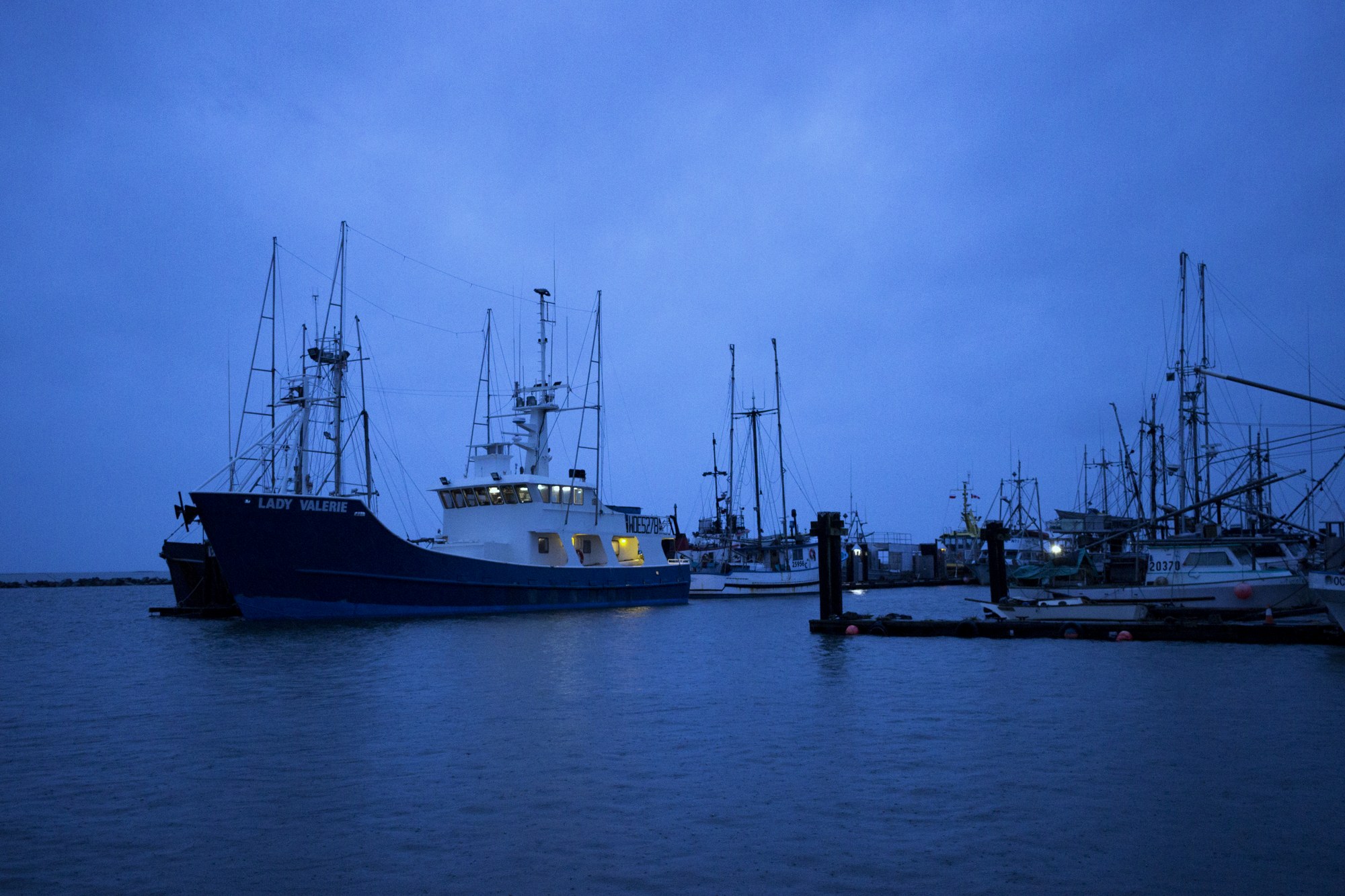 Fishing boats at Steveston wharf under a stormy sky