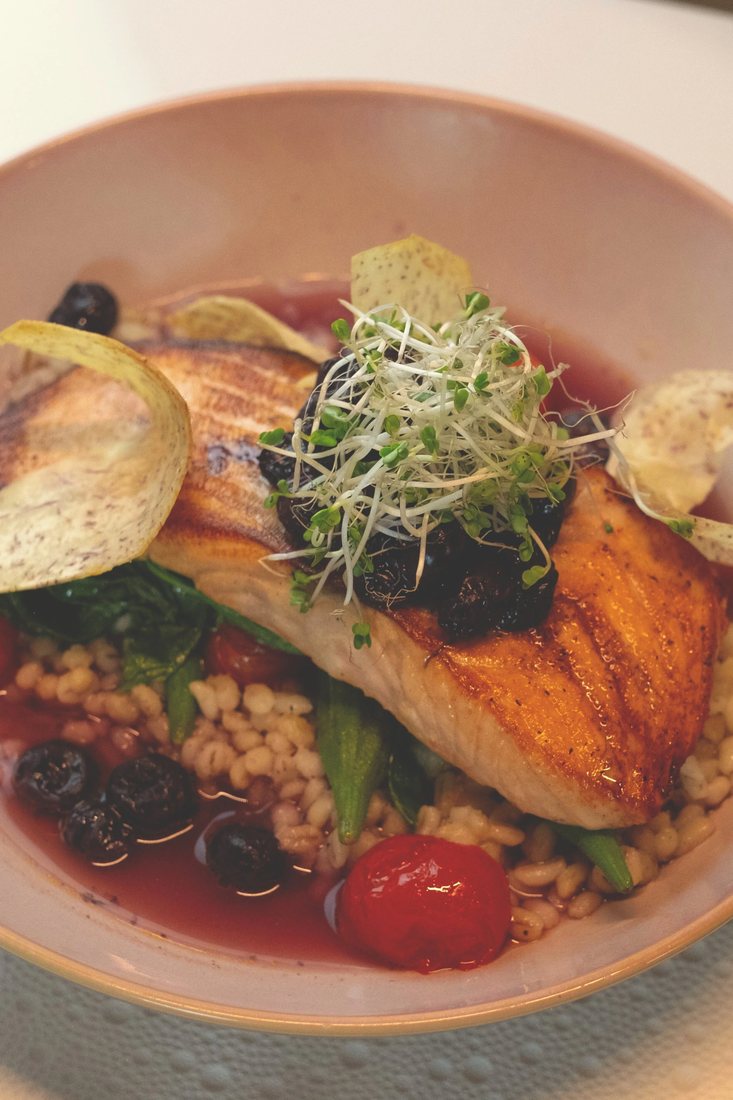 Salmon Berry Sinigang: seared coho salmon over pearl barley in a blueberry sinigang broth